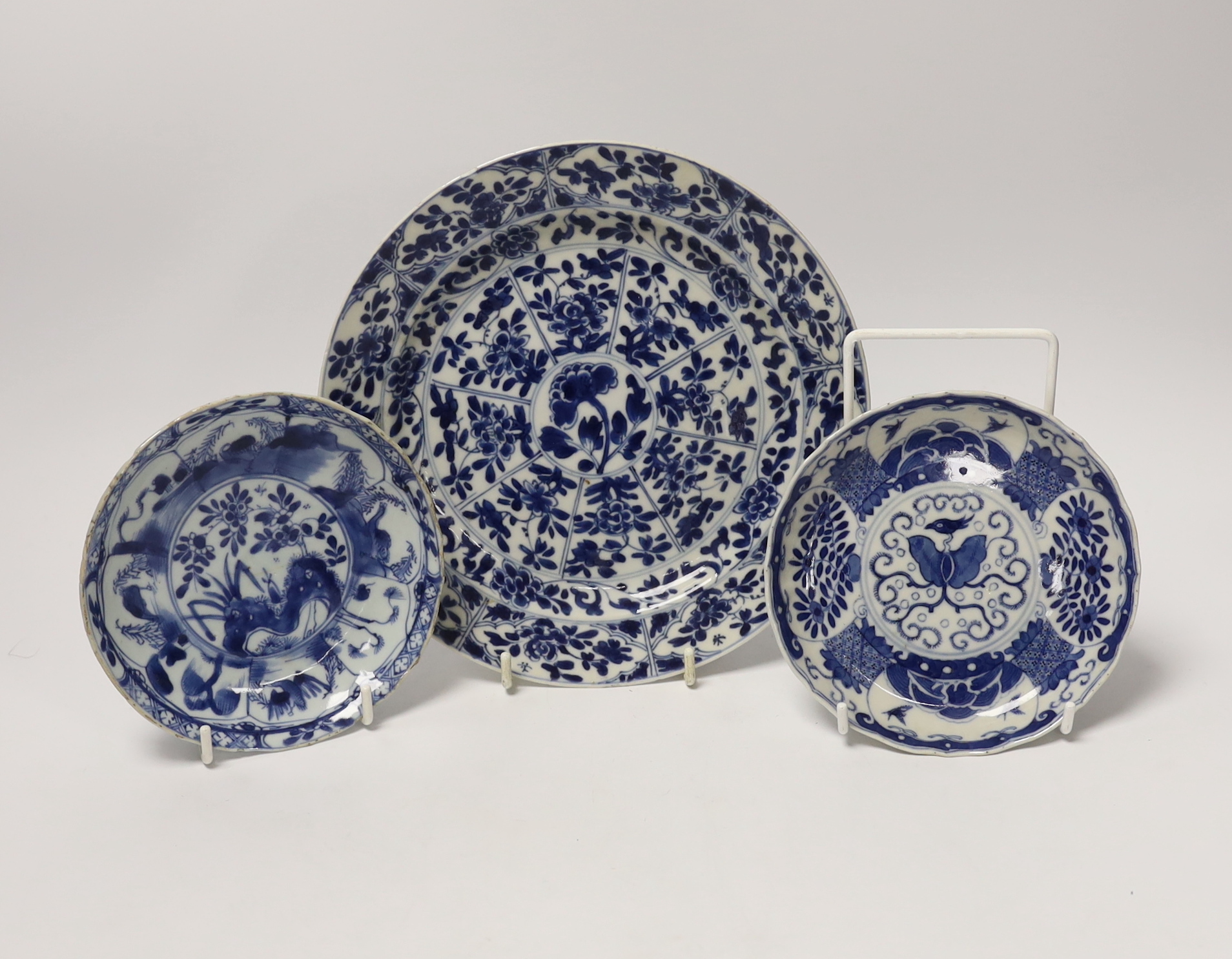 A Chinese Kangxi blue and white saucer dish and plate, and a similar 19th century blue and white saucer dish, largest 21cm in diameter